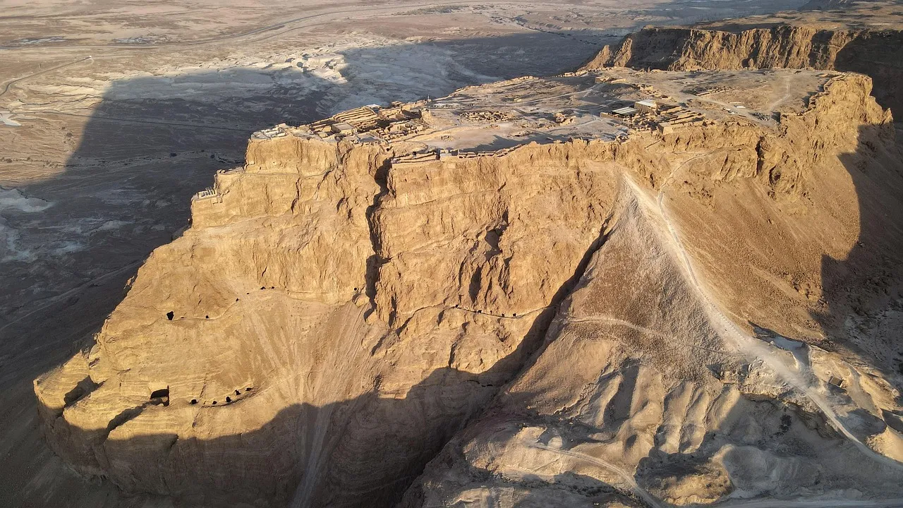 Aerial view of Masada fortress rising above the Dead Sea with the Roman siege ramp visible on its western face